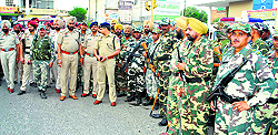 Police officers and Central Reserve Police Force personnel conduct a flag march in Ludhiana on Wednesday