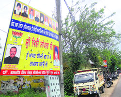 Hoardings with pictures of SAD-BJP leaders put up on the Dasuya-Hoshiarpur road.