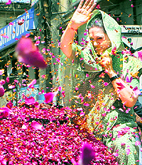Congress workers shower petals on Sonia Gandhi after she filed her nomination papers in Rae Bareli on Wednesday