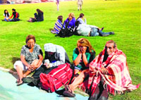 Locals take refuge at the city stadium following a tsunami alert after an earthquake hit off Chile's Pacific coast, in Iquique
