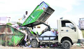 A DVWM vehicle dumps garbage in Dehradun on Thursday.
