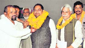 UKD (P) president Trivendra Singh Panwar welcomes new workers into the party in Dehradun on Thursday.