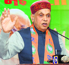 PK Dhumal addresses party workers at Solan on Thursday.