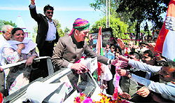 People greet Congress candidate for the Udhampur-Doda seat Ghulam Nabi Azad during campaigning in Kathua district on Thursday