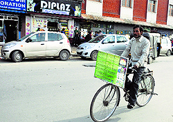 West Bengal resident Ram Prasad Naskar cycles to spread awareness on the ill-effects of global warming in Srinagar on Thursday