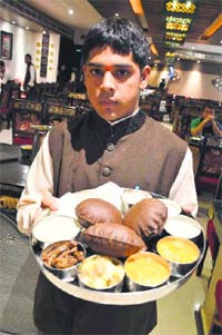 An attendant shows Navratra thali at a restaurant in Ludhiana.