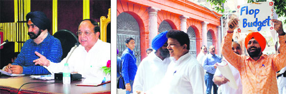 Mayor Bakshi Ram Arora addresses Municipal Corporation officials during the MC budget meeting; and (right) Congress councillors walk out during the meeting at Town Hall in Amritsar on Friday.