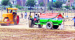 A roadroller and a tanker levelling HUDA ground for Rahul Gandhis rally in Sirsa on Friday