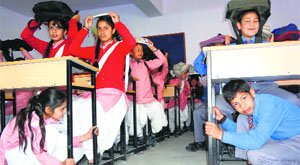 Students participate in a mock drill to combat natural disasters in Mandi on Friday.