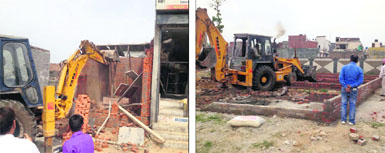 A shop being razed for construction without building plan and (right) a bulldozer razes foundations at an upcoming shopping complex in Ludhiana on Friday.