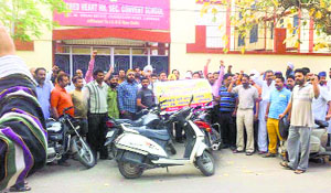 Parents of children studying at Sacred Heart Higher Secondary Convent School shout slogans against the school authorities on Chandigarh Road in Ludhiana on Friday.