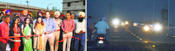Municipal Corporation officials formally open the up-ramp of the railway overbridge; and residents travel on it in Ludhiana on Friday.