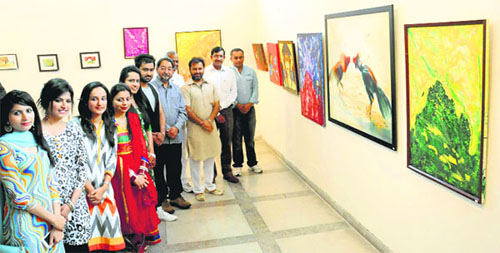 Artists with their works at a group exhibition A Joyful journey 
