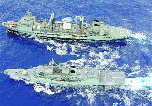 HMAS Toowoomba (below) conducts a replenishment-at-sea with HMAS Success (top) during the search for the missing Malaysia Airlines flight MH370 in the southern Indian Ocean.