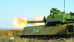 A Russian Gvodzika 122-mm Self-Propelled Howitzer fires during military exercises in southern Russia's Volgograd region.
