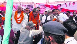 Chief Minister Harish Rawat meets party workers during a public meeting at Thal in Pithoragarh district on Saturday.