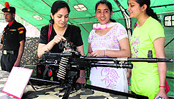 College girls look at Army weapons during a motivation seminar at DAV College, Jalandhar, on Saturday