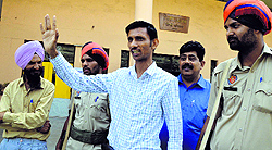 Jai Prakash Jain waves at his supporters after filing his nomination papers as an independent candidate