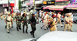Paramilitary forces along with the police carry out a march in the city on Saturday