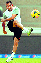 MS Dhoni loosens his limbs before practice on Saturday