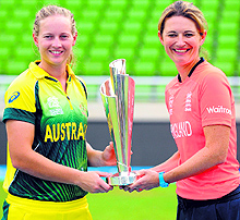 Australia women's team captain Meg Lanning (L) and England captain Charlotte Edwards pose with the trophy at the Sher-e-Bangla National Cricket Stadium