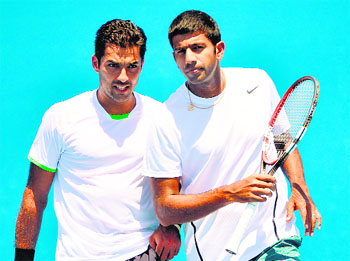 Rohan Bopanna with partner Aisam-Ul-Haq Qureshi of Pakistan(L) during their men's doubles match at the 2014 Australian Open tennis tournament in Melbourne