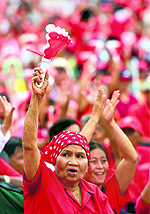Thai pro-government "Red Shirts" wave clappers during a rally in Bangkok on Saturday