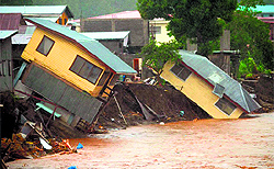 Floods ravage through solomon islands: Flood waters run past damaged homes in the Solomon Islands capital Honiara. Flash floods have killed at least 16 people and left 50,000 homeless in Honiara