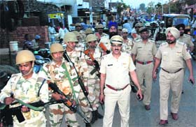 The Chandigarh-Panchkula police during a flag march at Mouli Jagran village in Chandigarh on Sunday