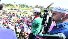 AAP candidate Gul Panag along with television actor Raghu Ram (right) interacts with residents of Dadu Majra village in Chandigarh on Sunday