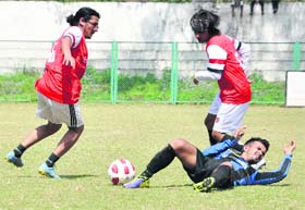 Players vie for the ball in a soccer match during the sports meet of DIT University at Pavillion Ground in Dehradun on Sunday