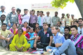 Local residents protest outside a gas agency on the Haridwar bypass in Dehradun on Saturday
