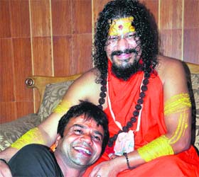 Noted Bollywood actor Raj Pal Yadav shares a light moment with Kali Peethadeeshwar Kailashanand Brahamchari at Mata Kali temple at Chandi Ghat in Haridwar on Sunday