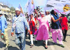 AAP workers during a roadshow in Dehradun on Sunday