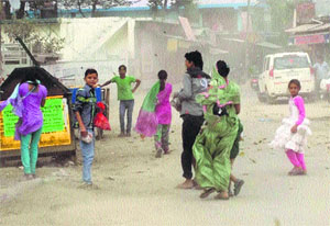 People caught in dust storm on a road in Kangra on Sunday