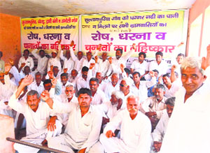 Villagers stage a dharna near bus stand at Sultanpuria village in Sirsa on Saturday