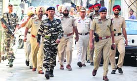 The police, along with personnel of paramilitary forces, take out a flag march in Ludhiana on Sunday.