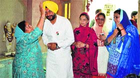 A woman blesses Congress candidate Ravneet Singh Bittu during his campaign.