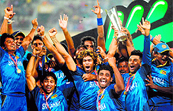 The Sri Lankan players celebrate with the World T20 trophy after beating India by six wickets in the final at the Shere Bangla National Stadium