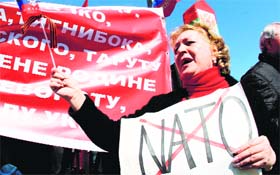 A pro-Russian protester holds a placard bearing a crossed out "Nato" during a rally in Donetsk on Sunday.