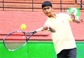 Krishan Hooda returns a shot during a match at the CLTA, Sector 10, in Chandigarh on Monday.