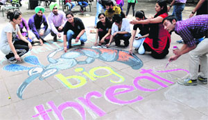 Students of Panjab University paint a message on World Health Day at the Student Centre on Monday.
