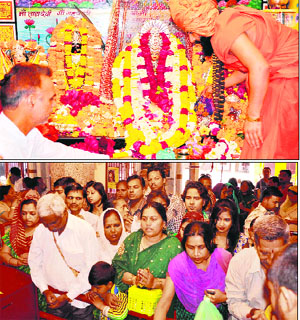 A saint bows before a deity; and (below) people pray on the occasion of Chaitra Navratra at the Maya Devi temple in Mayapur on Monday.