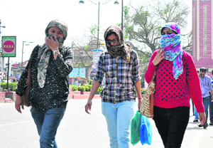 Girls cover their faces to get respite from the heat. The weather, however, changed for good in the afternoon when the city received light showers in Dehradun on Monday. 