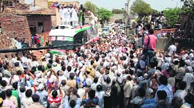 People listen to Chief Minister Bhupinder Singh Hooda at a village in Murthal during a roadshow on Monday.