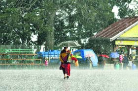 A woman walks with an umbrella during a heavy hailstorm in Shimla on Monday