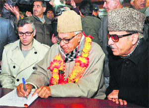 NC president Farooq Abdullah filing the nomination papers from Srinagar on Monday. He is flanked by Chief Minister Omar Abdullah and JKPCC chief Saifuddin Soz.