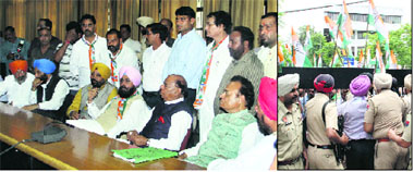 Congress candidate for the Jalandhar Lok Sabha seat Chaudhary Santokh Singh along with PPCC chief Partap Bajwa and his supporters wait for his turn to file nomination papers inside the DC office meeting hall in Jalandhar on Monday; and (right) cops close gates after hundreds of Congress supporters entered the DC office during the filing of nomination papers for the Lok Sabha seat.