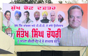 Photographs of PPP president Manpreet Badal and sitting Jalandhar MP Mohinder Singh Kaypee put up outside Congress Bhawan during the filing of nomination papers of Chaudhary Santokh Singh in Jalandhar on Monday. 