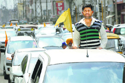SAD-BJP candidate Manpreet Singh Ayalis supporters on the way to the Mini-Secretariat where he filed his nomination papers on Monday. A Tribune photograph